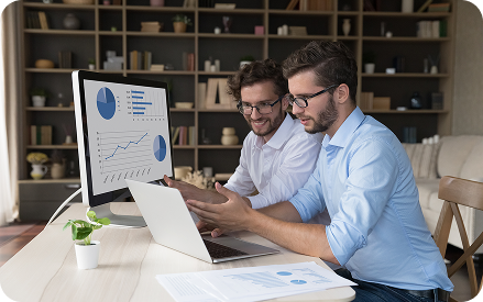 Team reviewing marketing reports on a desktop monitor