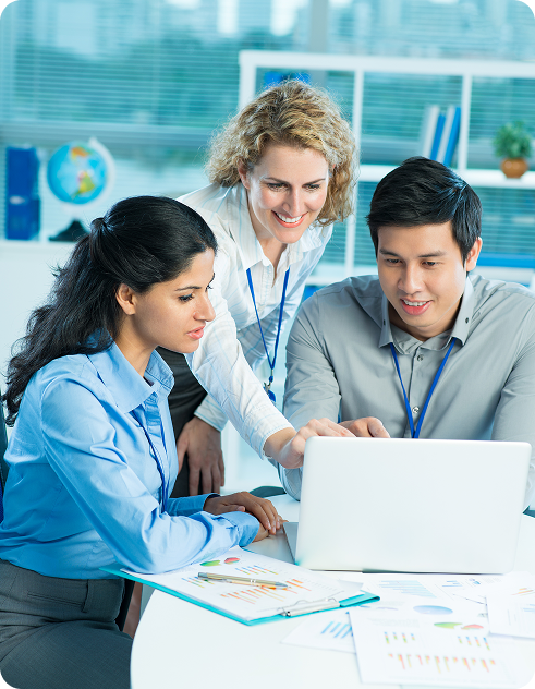 Business team reviewing development strategy on a laptop