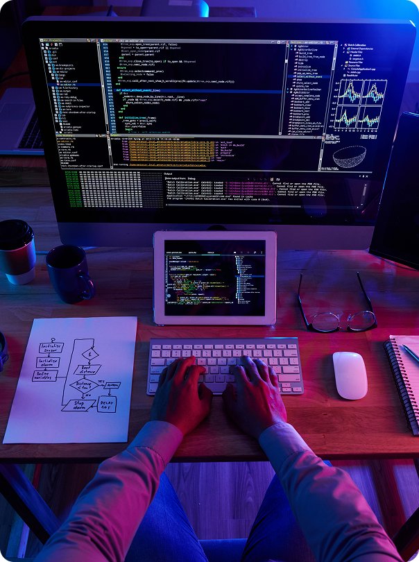 Young app developer using desktop computer