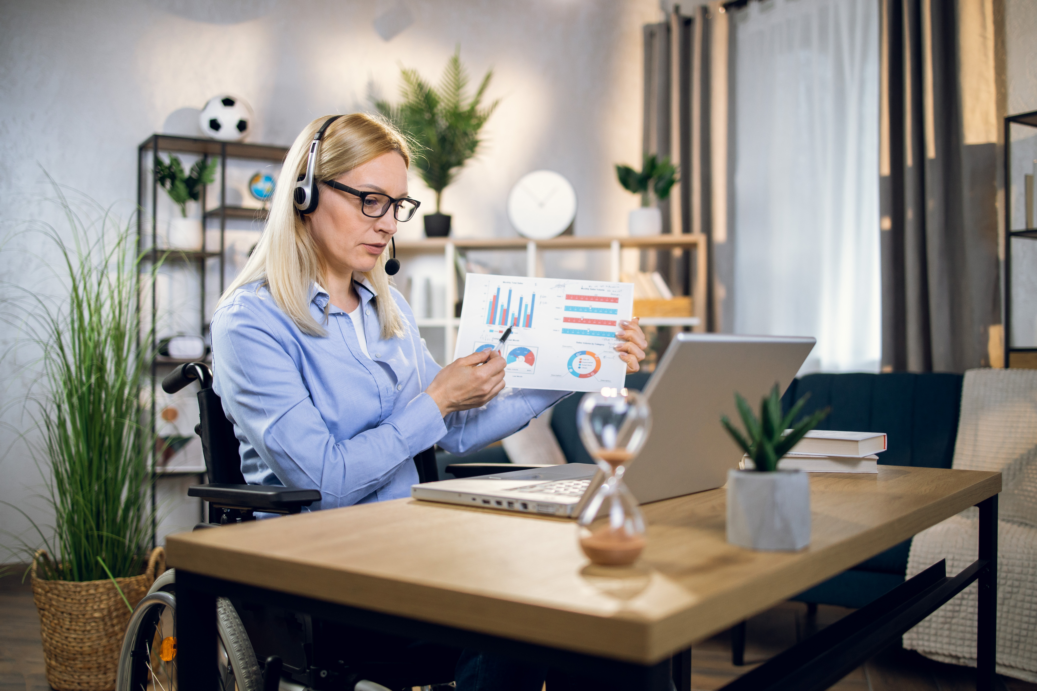 Virtual assistant reviewing business reports at a desk